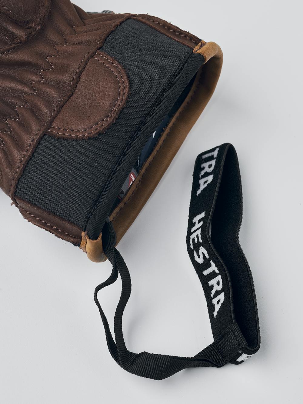 Dunkelblauer Fausthandschuh aus Rindsleder mit dunkelbrauner Innenhand und verstellbarem Handgelenkverschluss (6 oder 6)