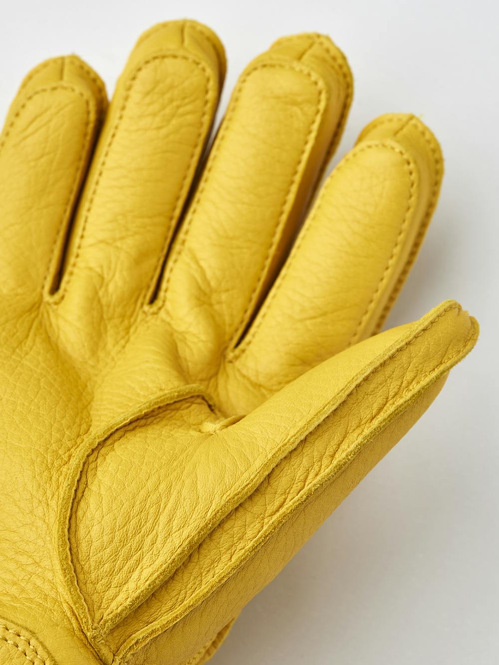 Yellow machine-sewn deerskin glove with gray knitted cuff
 (2 of 3)