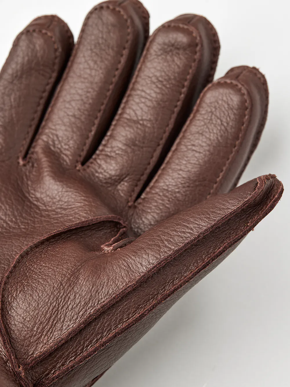 Brown machine-sewn deerskin glove with knitted cuff
(2 of 3)