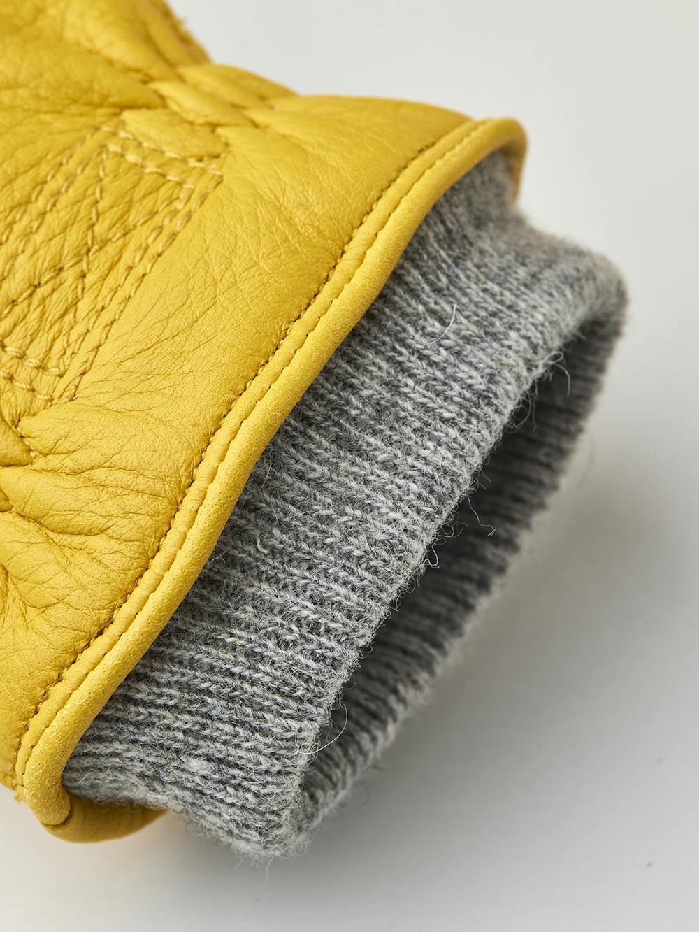 Yellow machine-sewn deerskin glove with gray knitted cuff
(3 of 3)