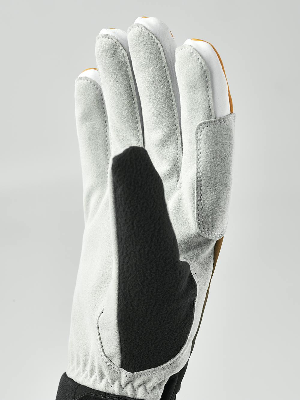 Svart och orange längdskidhandske i tyg med grå innerhand i syntetisk mocka
(5 av 10)