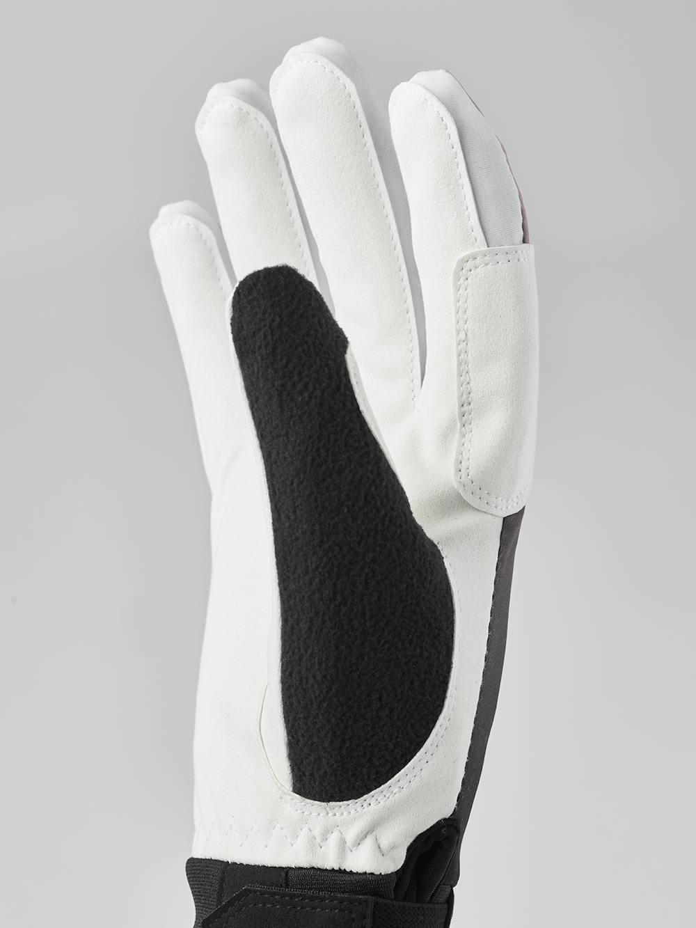 Svart och rosa längdskidhandske i tyg med vit innerhand i syntetisk mocka
(5 av 7)