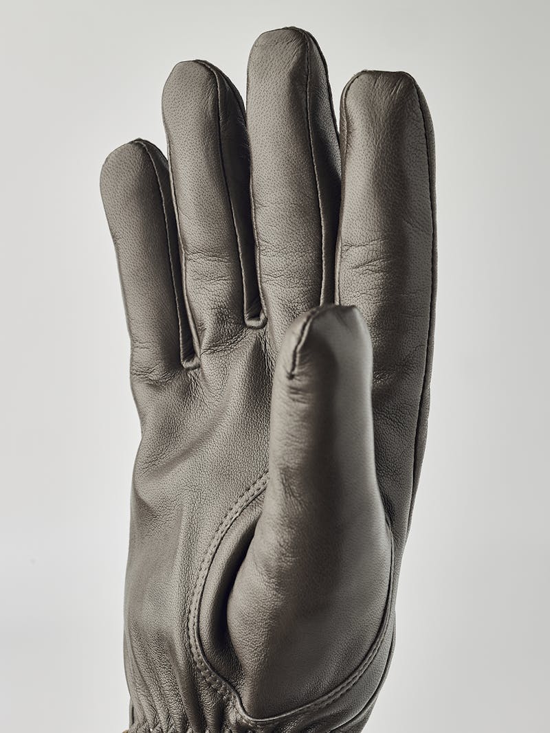 Gray machine-sewn hairsheep leather glove with leather strap
 (5 of 5)