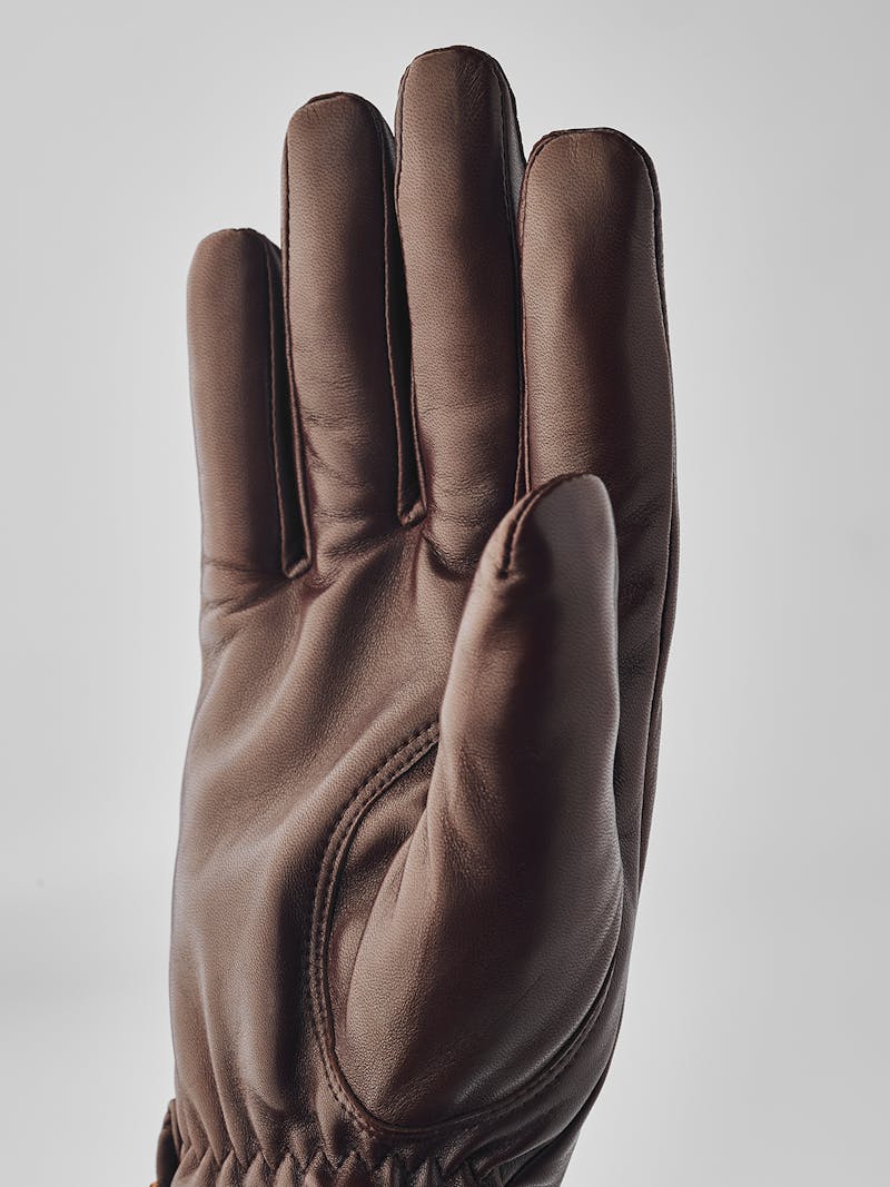 Brown machine-sewn hairsheep leather glove with leather strap
 (5 of 5)