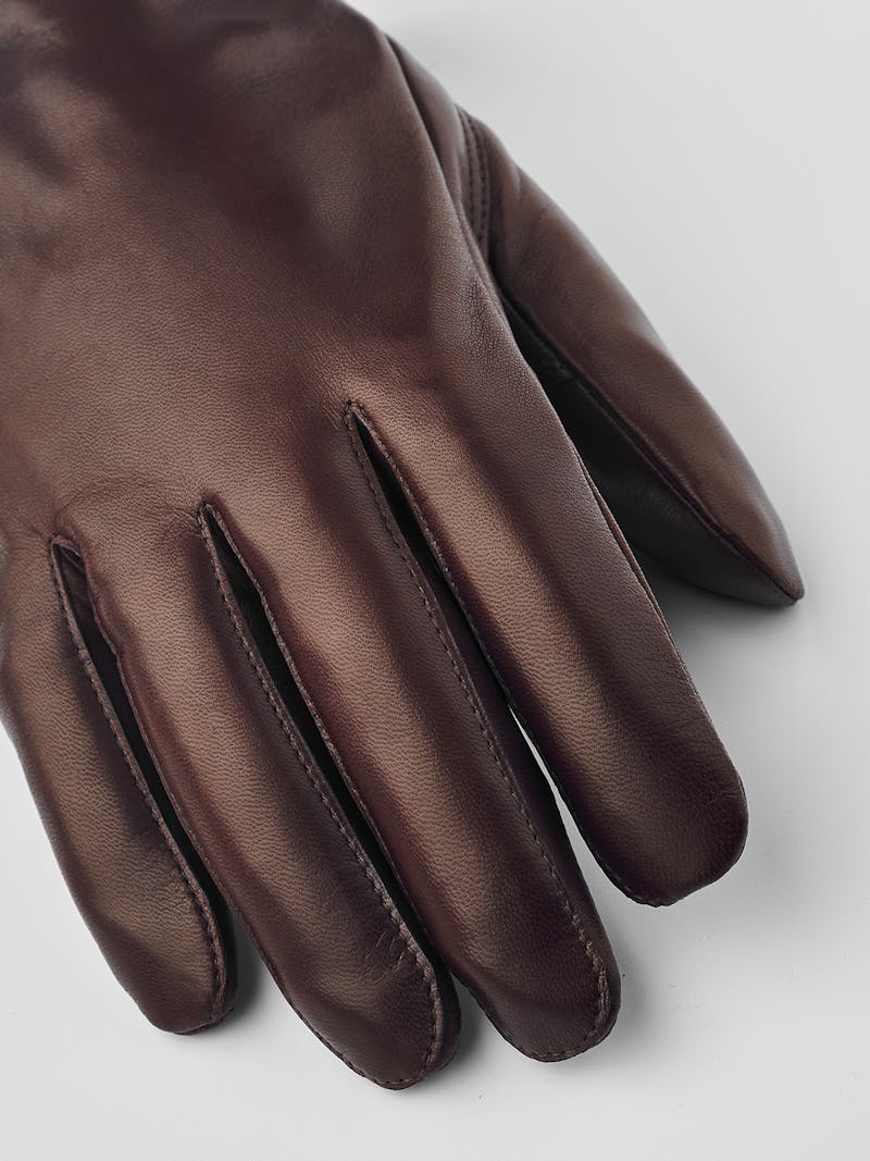 Brown machine-sewn hairsheep leather glove with leather strap
 (2 of 5)